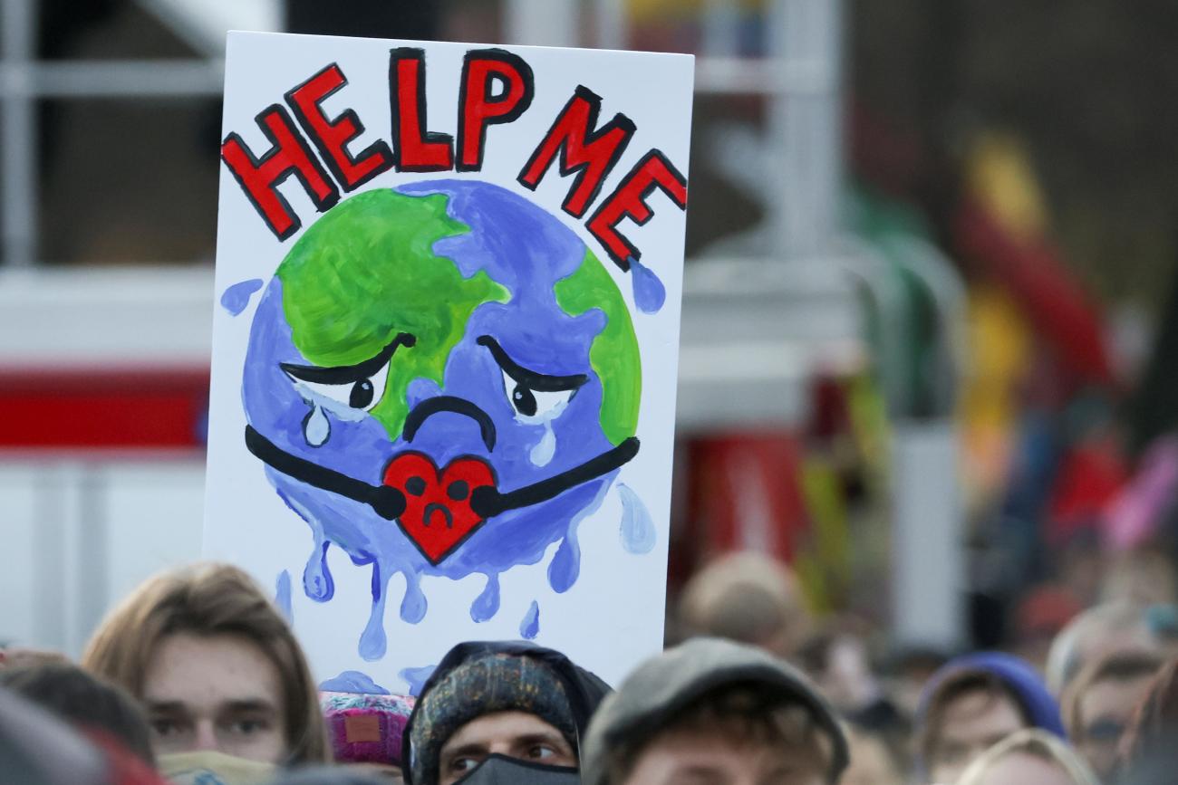 People carry a sign as they attend a protest during the UN Climate Change Conference (COP26), in Glasgow, Scotland, Britain, November 6, 2021.