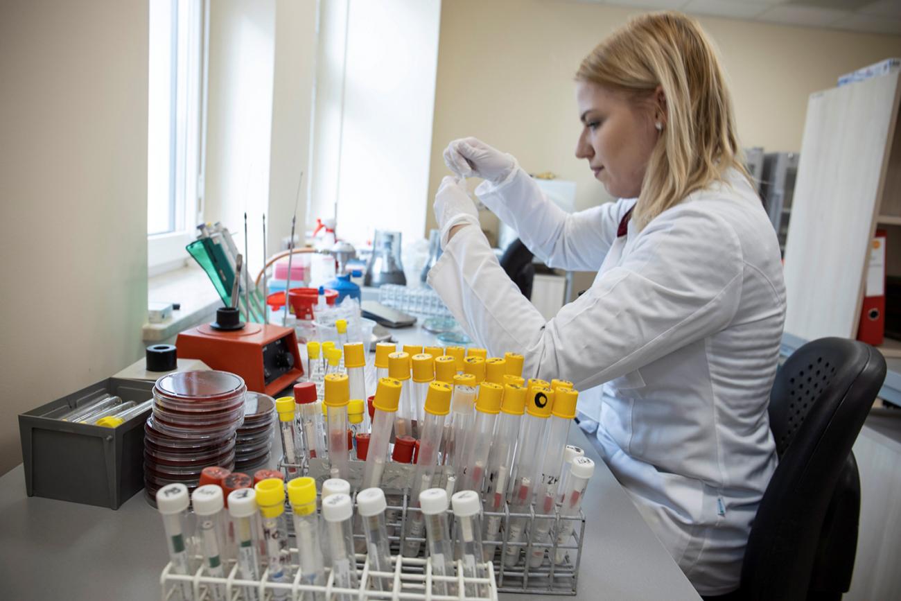 Molecular epidemiology: a laboratory worker at the Wielkopolska Center for Pulmonology and Thoracic Surgery in Poznan, Poland performs diagnostic tests for the novel coronavirus on March 3, 2020. Picture shows a lab worker in a white lab coat sitting at a bench surrounded by test tubes preparing samples for analysis. REUTERS/Agencja Gazeta/Lukasz Cynalewski