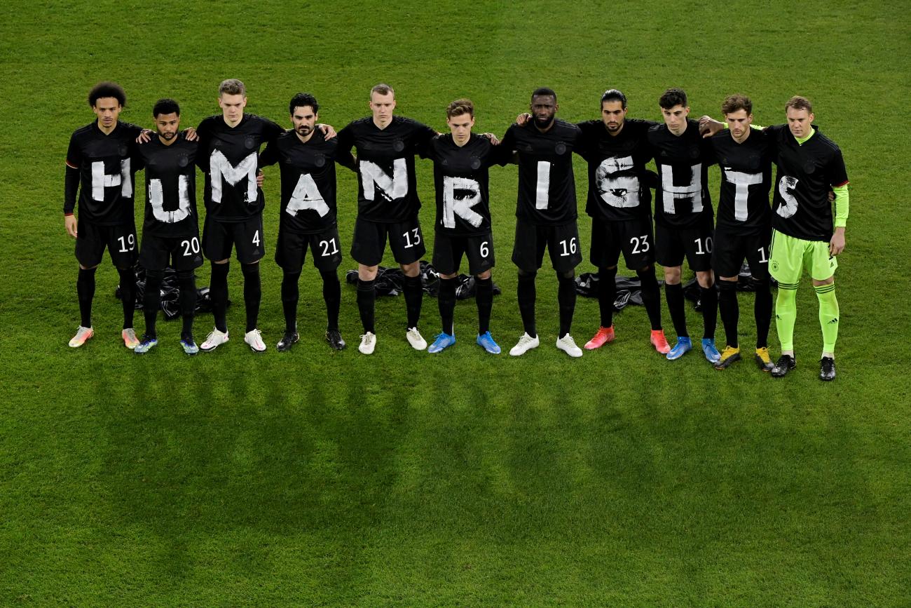 Germany soccer players pose before a World Cup match, bringing attention to labor rights abuses in Qatar, at MSV-Arena in Duisburg, Germany, on March 25, 2021. Pool via REUTERS/Tobias Schwarz