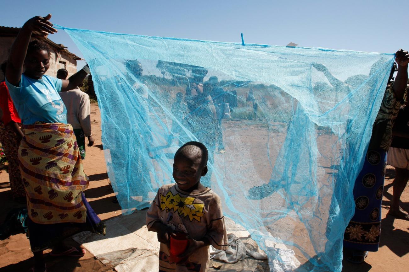 Zambian villagers display a mosquito net in Matongo village, in Zambia, on April 23, 2008.