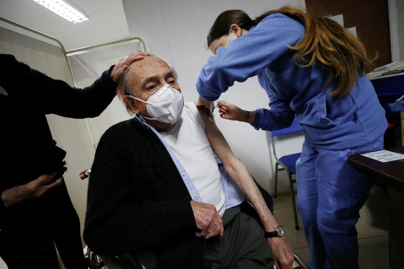 An elderly man receives an AstraZeneca COVID vaccine as Chile starts a booster campaign for those inoculated with the Sinovac vaccine. Photo taken on August 11, 2021.