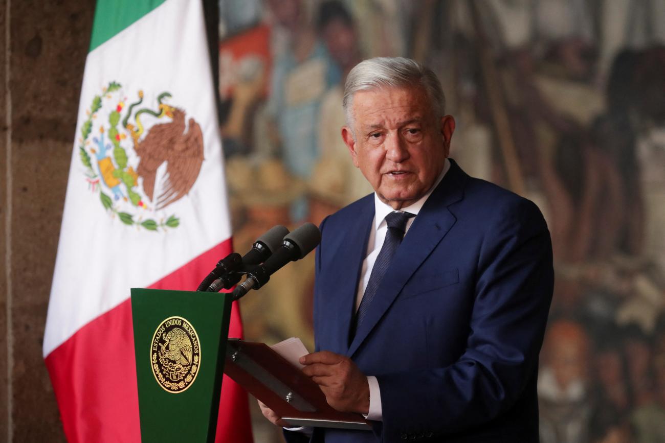 Mexican President Andres Manuel Lopez Obrador stands at a podium.