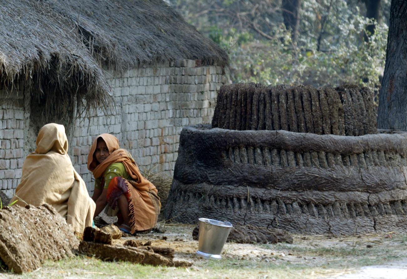 Dalit women work with cow dung on the outskirts of Lucknow, India, on January 16, 2008.