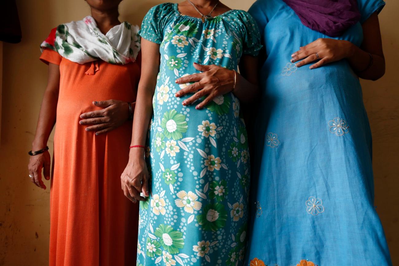 Surrogate mothers (L-R) Daksha, 37, Renuka, 23, and Rajia, 39, pose for a photograph inside a temporary home for surrogates provided by Akanksha IVF centre in Anand town, south of of Ahmedabad, India.