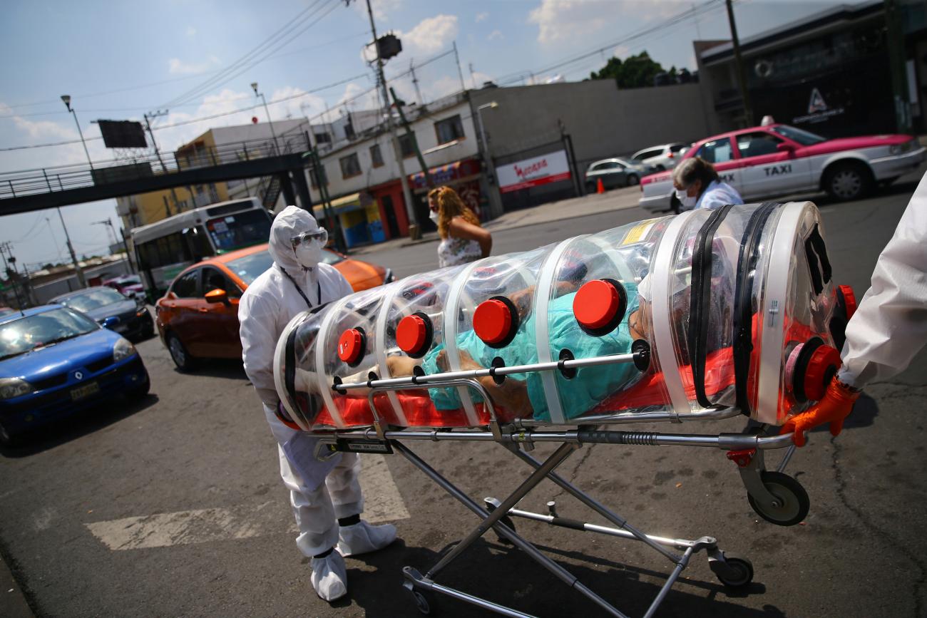 A patient suffering from COVID-19 and diabetes, is pictured inside a capsule as Red Cross paramedics transfer him from a hospital to another in Mexico City, Mexico, on June 8, 2020
