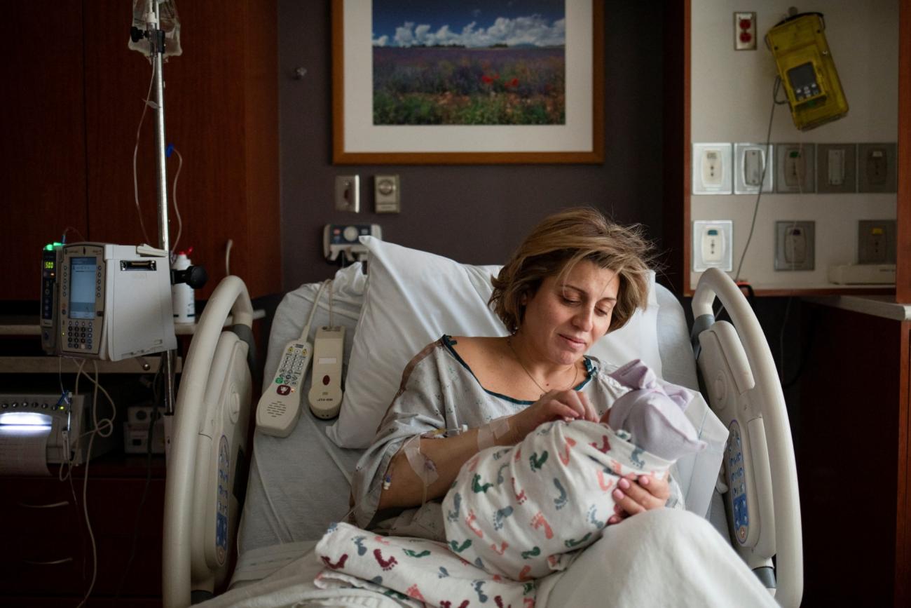 holds her newborn child, Malaki, after giving birth in the Family Birth Center at Beaumont Hospital in Royal Oak, Michigan, U.S., February 1, 2022.
