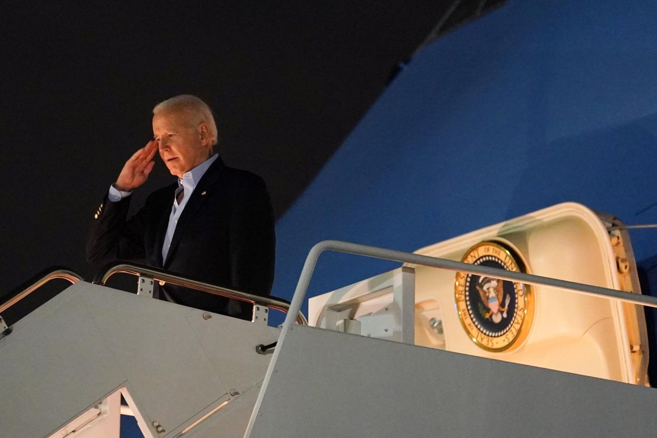 U.S. President Joe Biden salutes from Air Force One as he departs for Egypt to attend the COP27 summit from Joint Base Andrews in Maryland, on November 10, 2022.