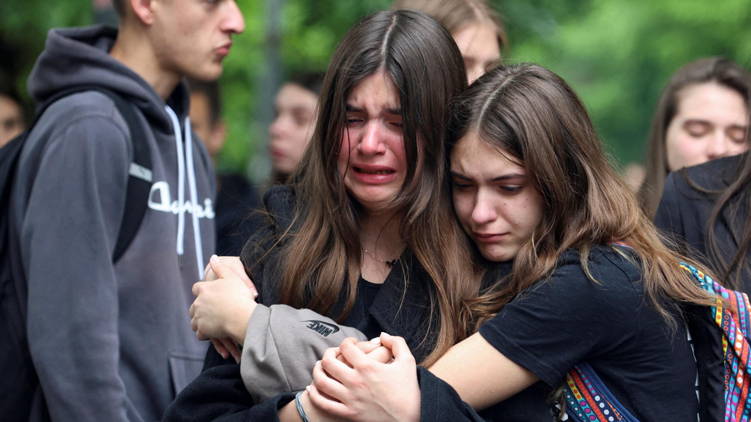 People react as they pay tribute following a school mass shooting after a boy opened fire on others, killing fellow students and staff in Belgrade, Serbia, May 4, 2023. 