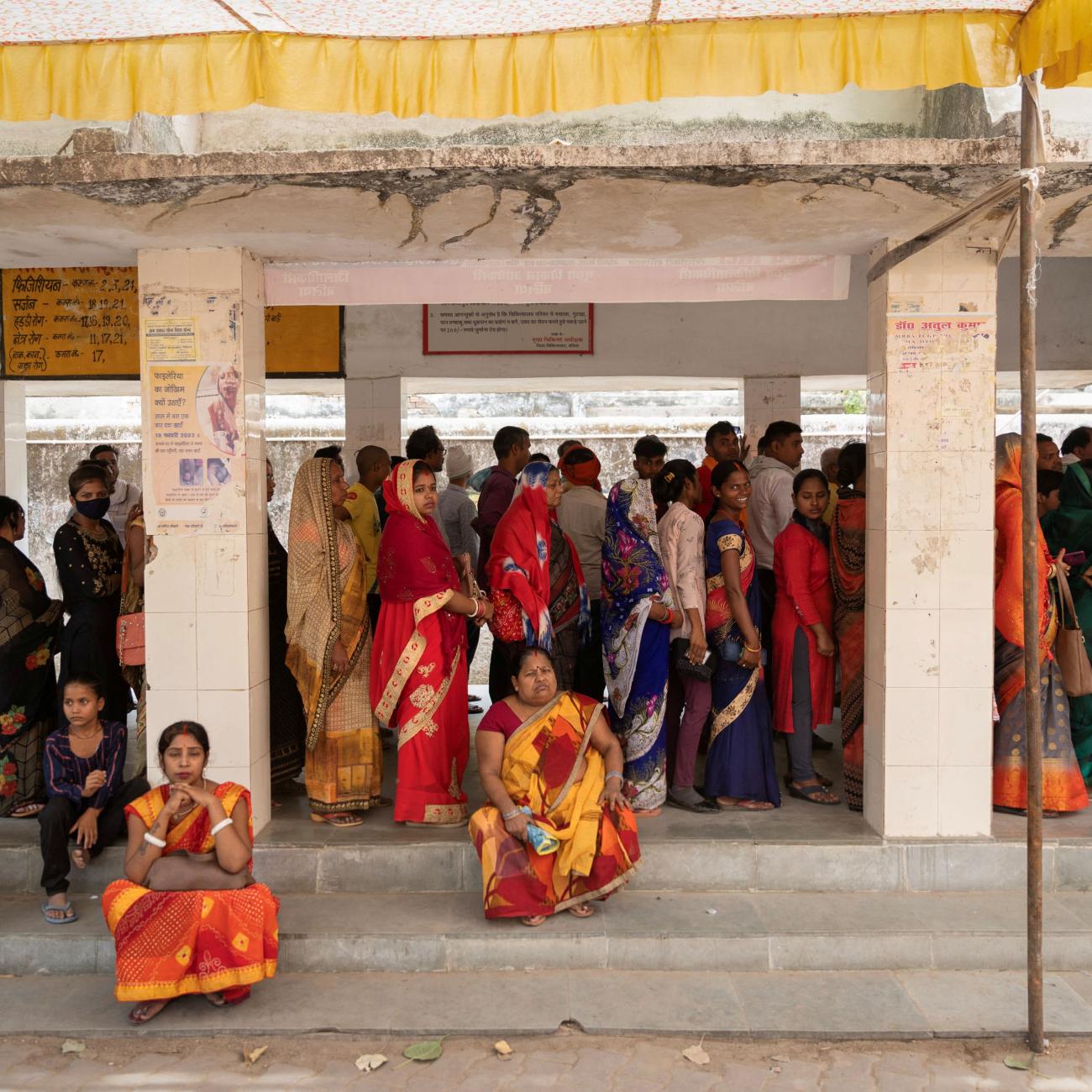 People stand in queues at a registration center at a hospital on a hot summer day in Ballia District in the northern state of Uttar Pradesh, India, June 21, 2023.