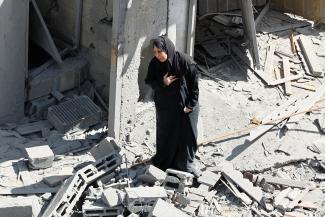 A Palestinian woman reacts at the site of Israeli strikes on houses, in Rafah in the southern Gaza Strip, on October 17, 2023