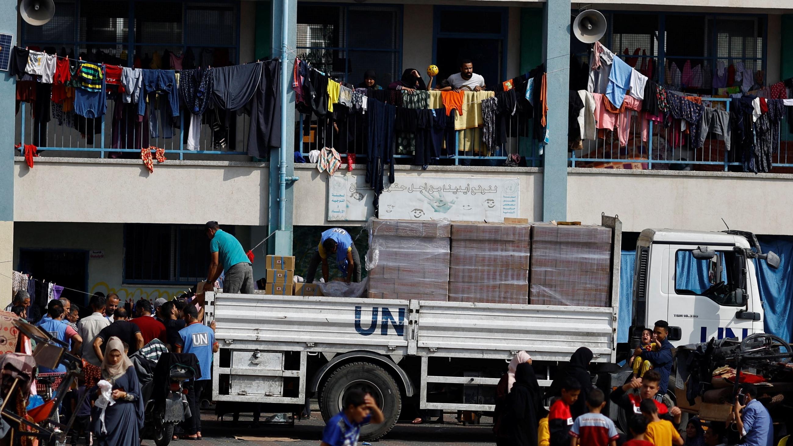 A UN aid truck is seen distributing aid to Palestinians