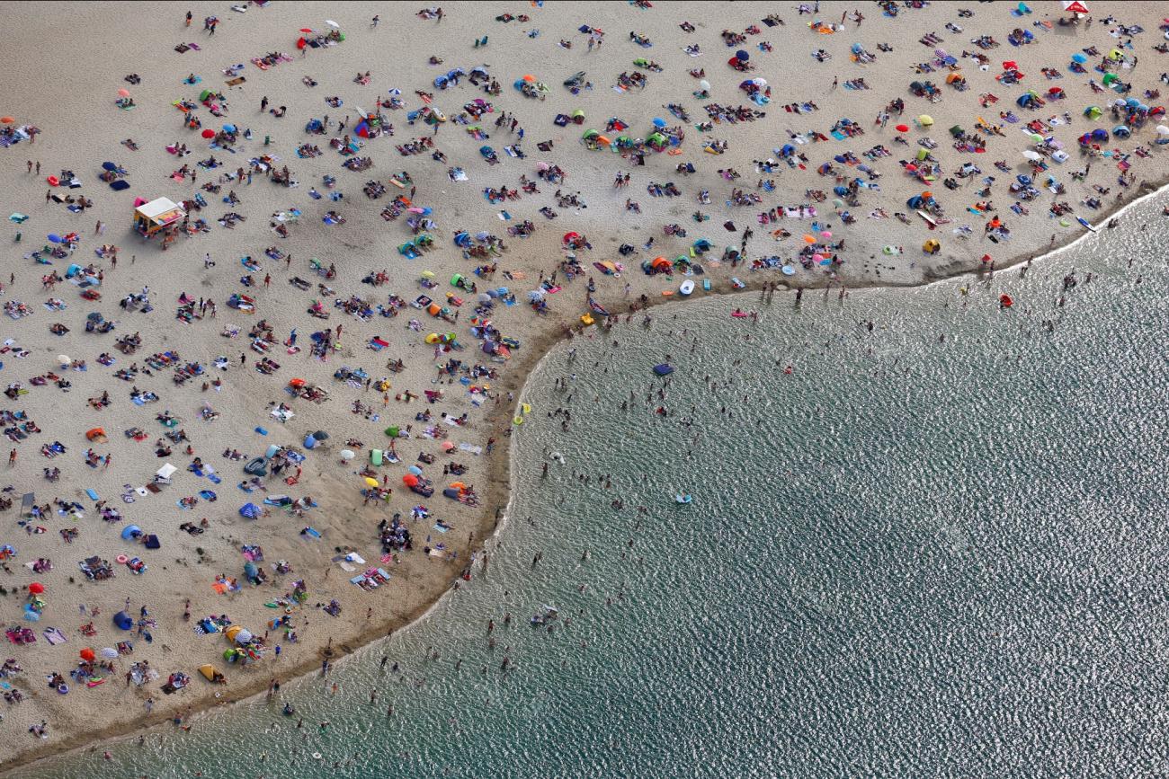 an arial view shows people at the beach on the shores of lake Silbersee