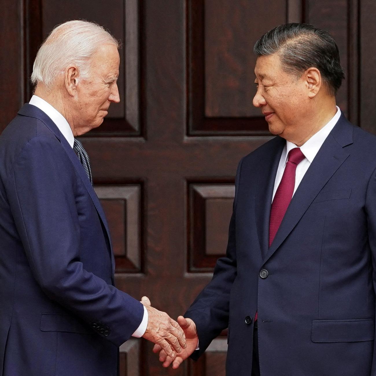 President Joe Biden shakes hands with President Xi Jinping