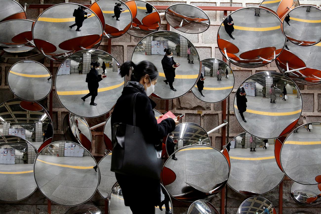 A woman wearing a mask to prevent the coronavirus is reflected in mirrors in Seoul, South Korea on February 24, 2020. This is an amazing image of a woman walking by a display of spherical mirrors, the sort of which someone might place on a corner to see a wide angle. She is wearing a black face mask and is reflected in all the mirrors. REUTERS/Heo Ran