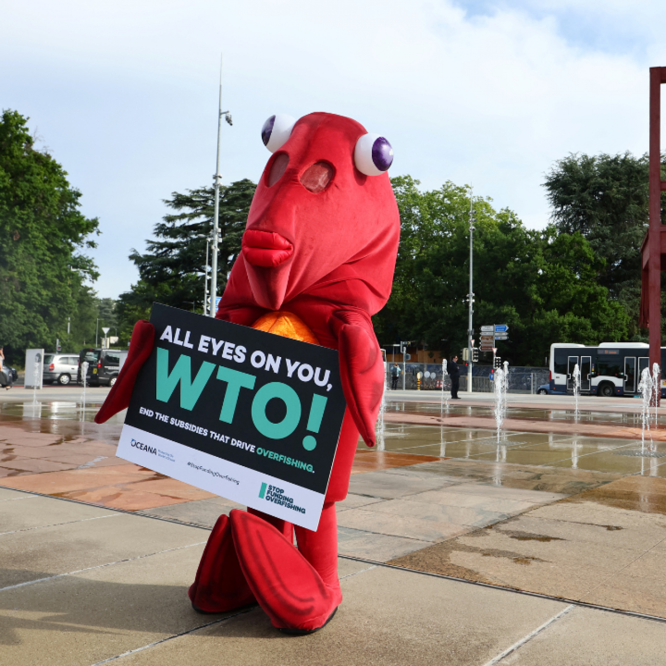 Finley the fish, a person dressed in a life-size red fish costume, poses during World Ocean Day ahead of the World Trade Organization Ministerial Conference (MC12) holding a sign to protest harmful fisheries subsidies. Photo taken in Geneva, Switzerland on June 8, 2022.
