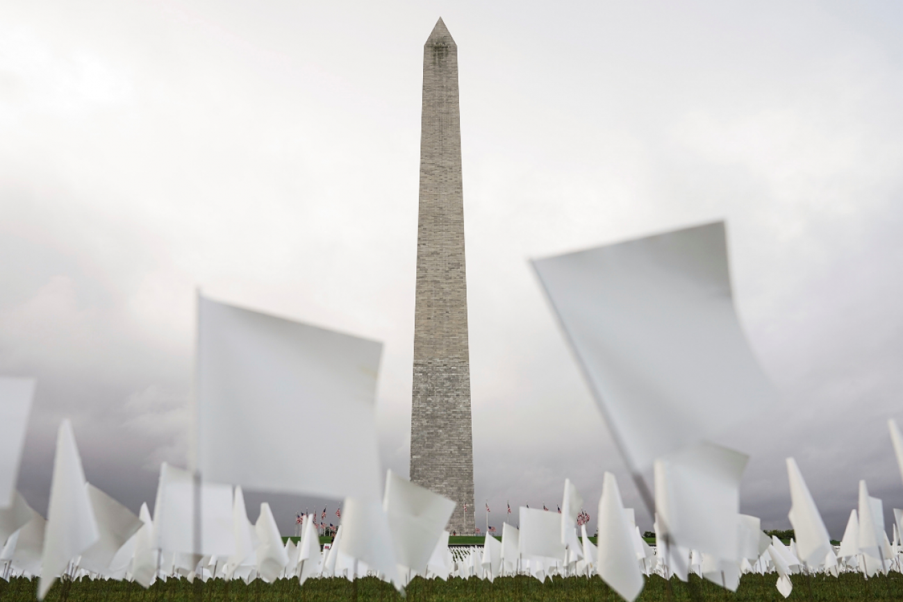 White flags placed across 20 acres of the National Mall represent Americans who have died of COVID-19. The Washington Monument stands in the distance, in Washington, D.C., September 2021. 